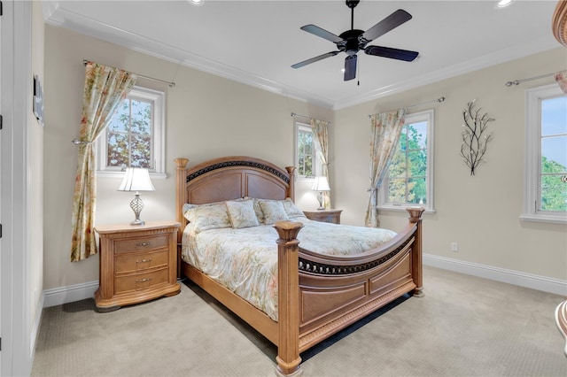 carpeted bedroom featuring multiple windows, ceiling fan, and ornamental molding