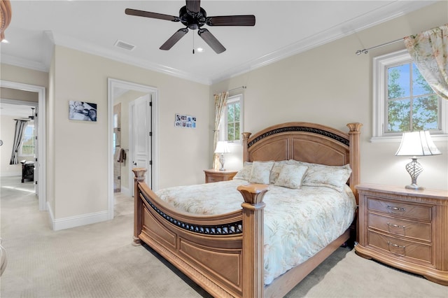 bedroom featuring multiple windows, ceiling fan, and light carpet