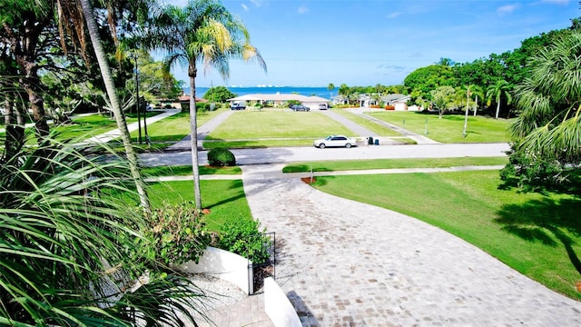 surrounding community with a lawn and a water view