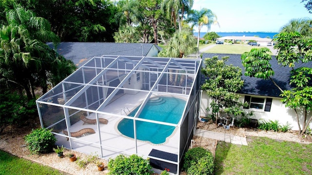 view of swimming pool with a lanai and a patio