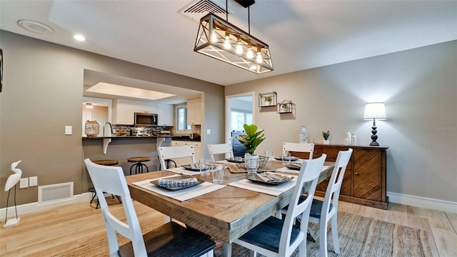 dining room with light wood-type flooring