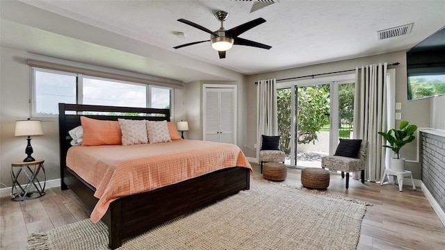 bedroom featuring ceiling fan, light wood-type flooring, and a closet