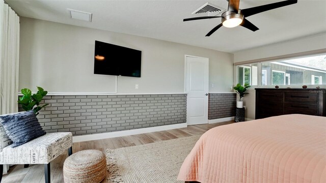 bedroom with ceiling fan and light hardwood / wood-style floors