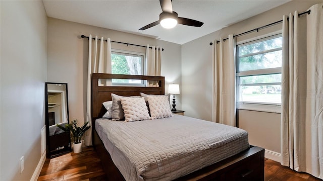 bedroom with ceiling fan and dark wood-type flooring