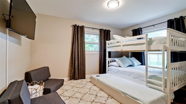 bedroom with multiple windows and a textured ceiling