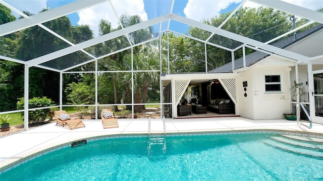 view of swimming pool featuring outdoor lounge area, a lanai, and a patio area