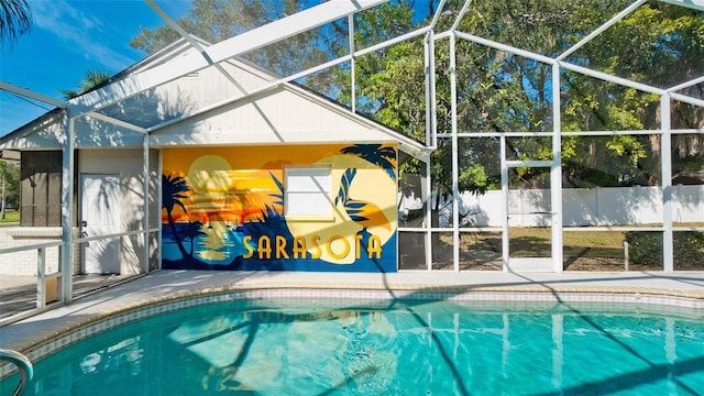 view of pool featuring glass enclosure