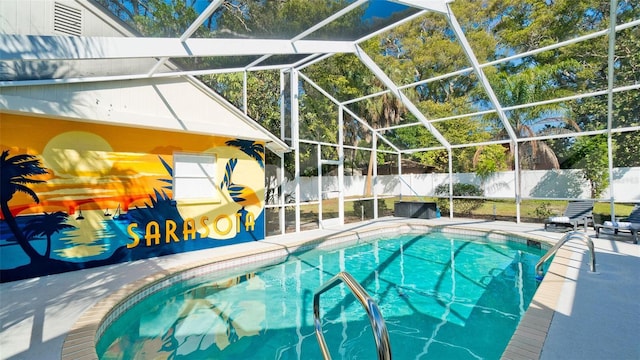 view of swimming pool with a lanai and a patio