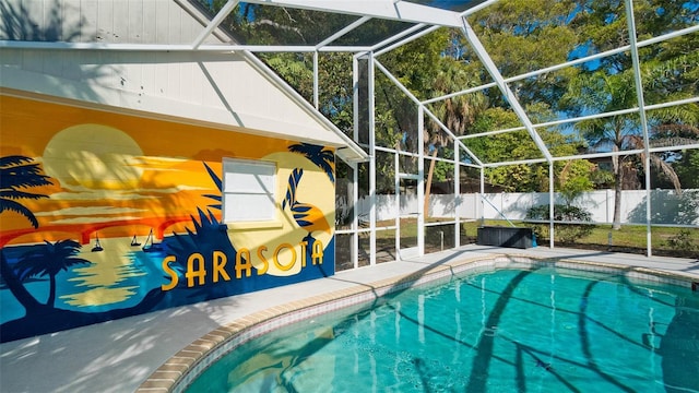 view of swimming pool with glass enclosure