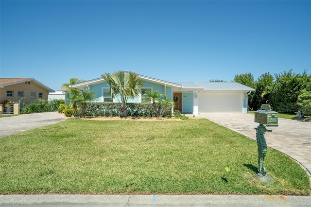 single story home featuring a garage and a front lawn