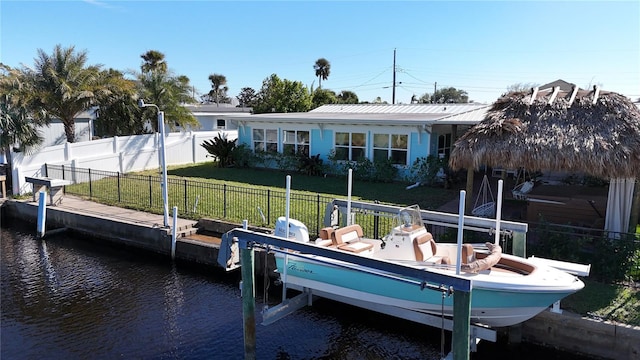 exterior space featuring a lawn and a water view