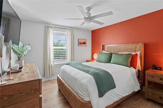 bedroom featuring ceiling fan and light hardwood / wood-style flooring