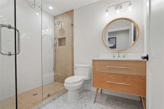 bathroom featuring toilet, vanity, and walk in shower