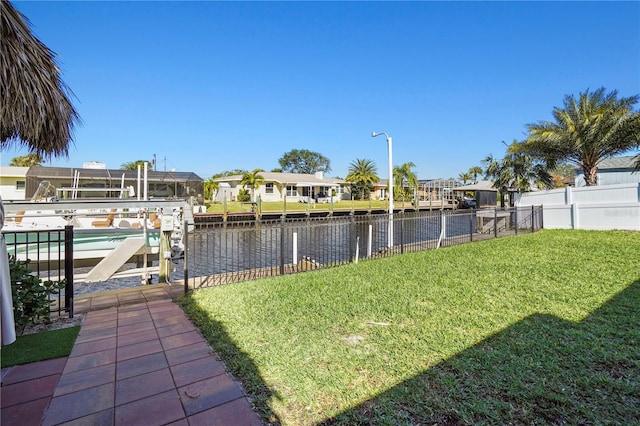 view of yard featuring a water view and a dock