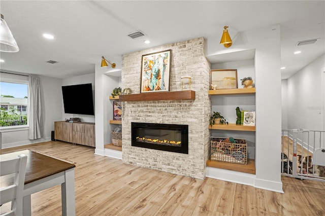 living room featuring light hardwood / wood-style floors and a fireplace