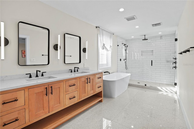 bathroom with vanity and shower with separate bathtub