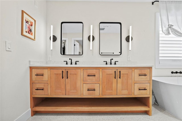 bathroom with vanity and a tub