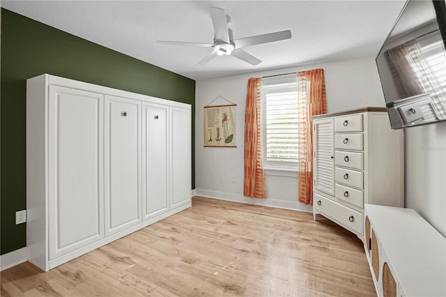 unfurnished bedroom with ceiling fan and light hardwood / wood-style floors