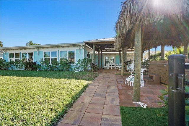 view of front of home with a front yard and a patio