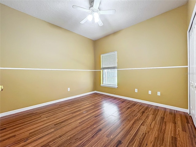 spare room with ceiling fan, wood-type flooring, and a textured ceiling