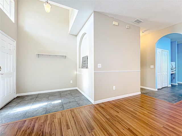 entrance foyer featuring a textured ceiling and dark hardwood / wood-style flooring