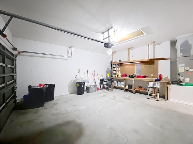 garage featuring electric water heater and a garage door opener