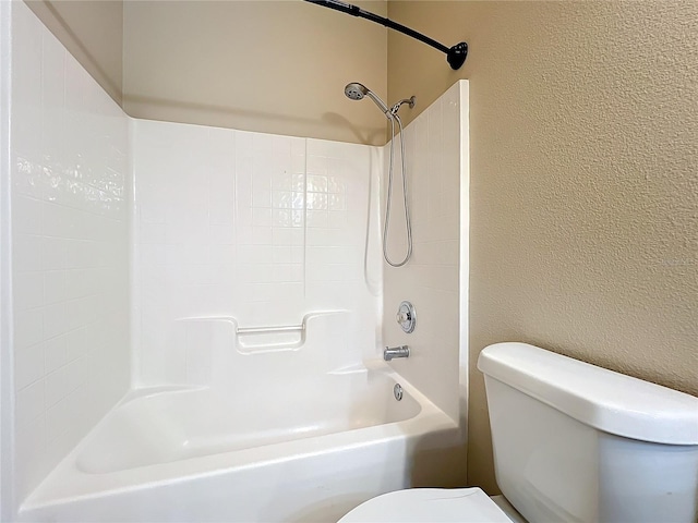 bathroom featuring shower / bath combination and toilet