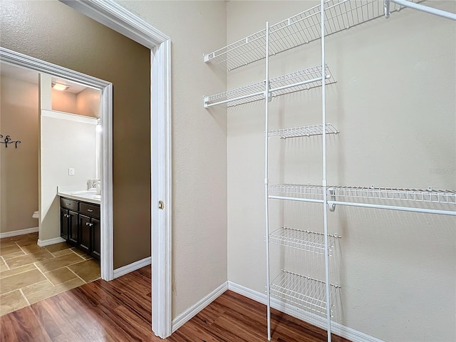 spacious closet featuring hardwood / wood-style floors