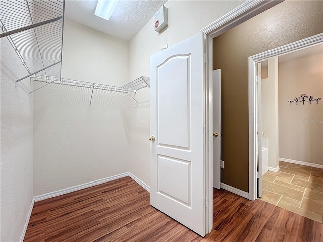 spacious closet with hardwood / wood-style flooring