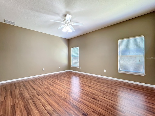 unfurnished room featuring hardwood / wood-style floors, a textured ceiling, and ceiling fan