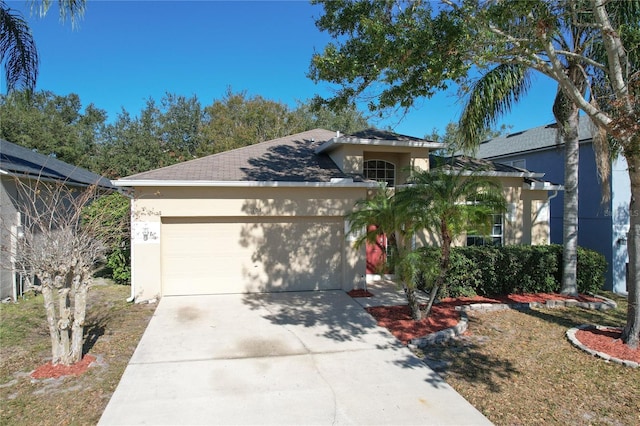 view of front of house featuring a garage and a front lawn