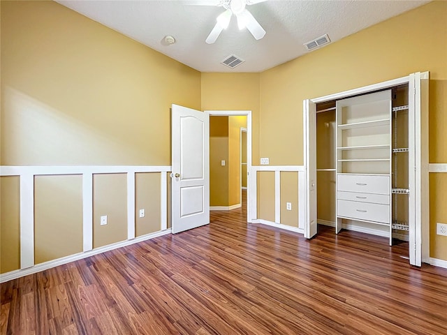 unfurnished bedroom featuring a textured ceiling, dark hardwood / wood-style floors, and ceiling fan