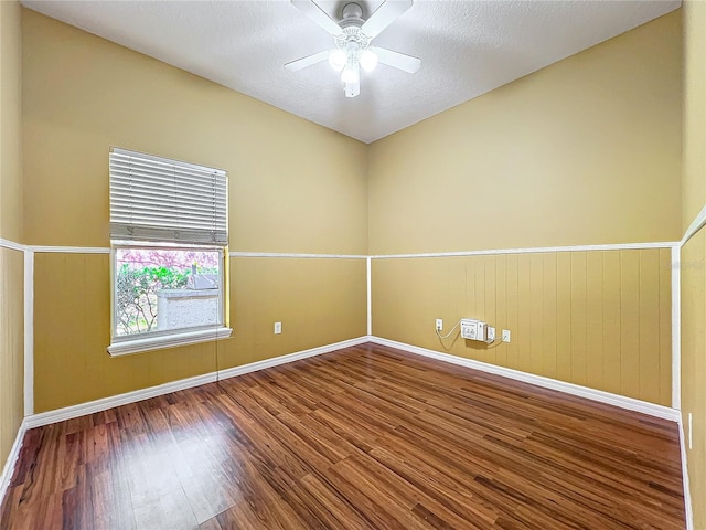 empty room with ceiling fan and hardwood / wood-style floors