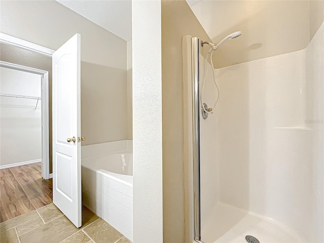 bathroom featuring vaulted ceiling and shower with separate bathtub