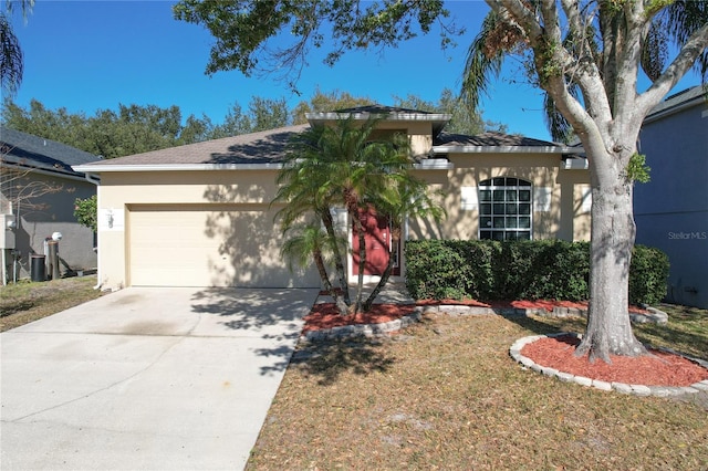 view of front of property with a garage and a front yard