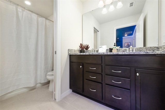 bathroom with tile patterned flooring, vanity, and toilet