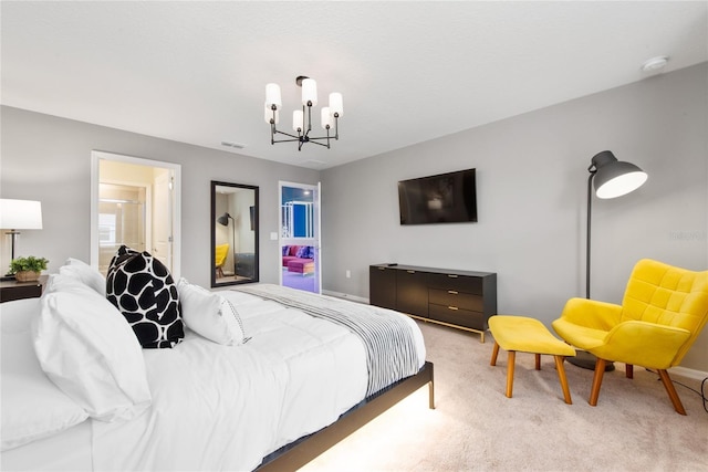 bedroom with carpet flooring, connected bathroom, and a notable chandelier