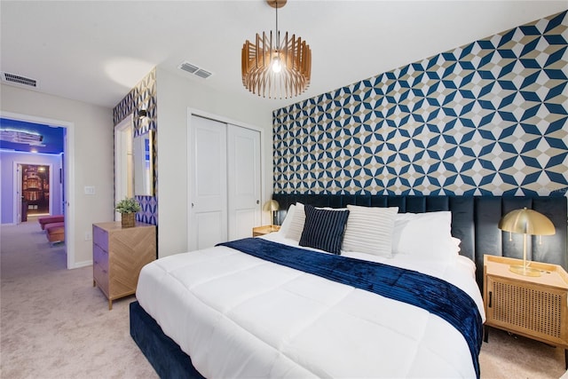 bedroom with light colored carpet and a closet