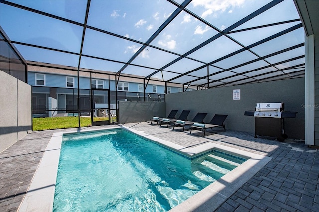 view of swimming pool with a lanai, grilling area, and a patio area