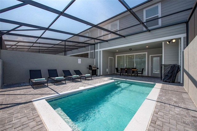 view of swimming pool with a patio and a lanai