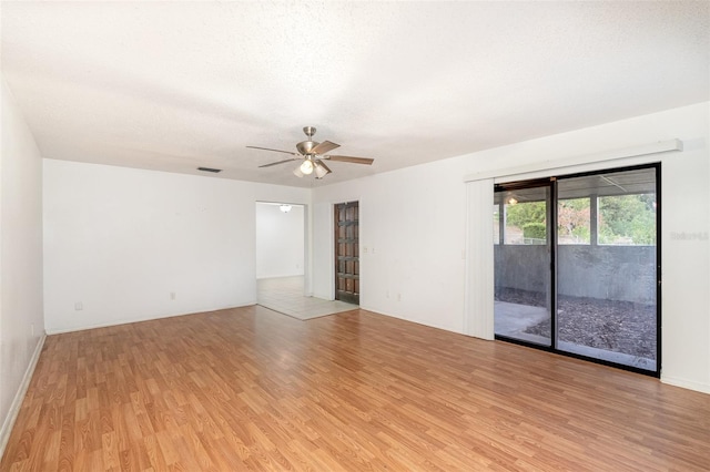 unfurnished room with ceiling fan, light hardwood / wood-style floors, and a textured ceiling