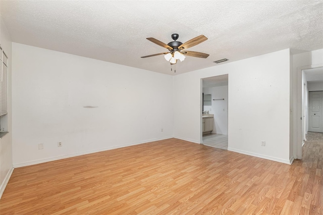 unfurnished bedroom with ensuite bath, ceiling fan, a textured ceiling, and light hardwood / wood-style flooring