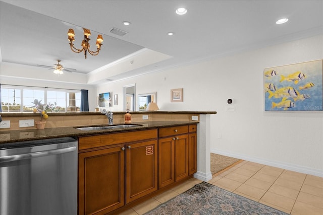 kitchen featuring dark stone countertops, dishwasher, ceiling fan with notable chandelier, and sink