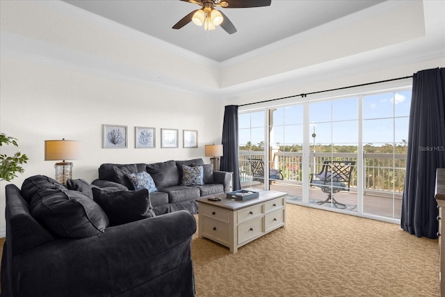 carpeted living room featuring plenty of natural light, crown molding, and ceiling fan