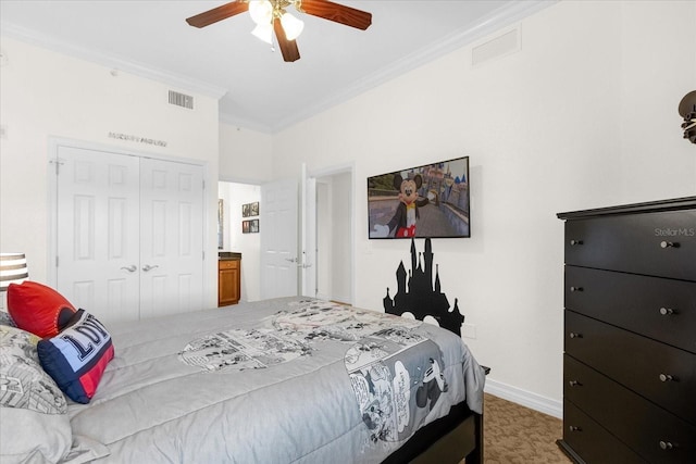 bedroom with dark colored carpet, a closet, crown molding, and ceiling fan