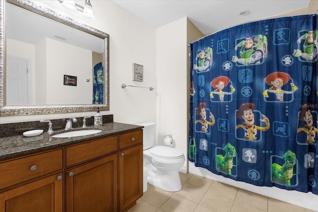 bathroom with tile patterned floors, vanity, toilet, and a shower with curtain