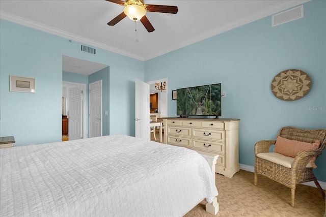 carpeted bedroom featuring ceiling fan and ornamental molding