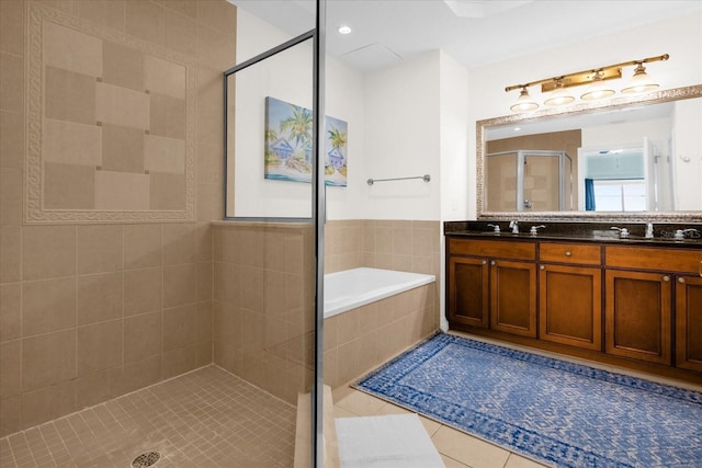 bathroom with tile patterned floors, vanity, and separate shower and tub