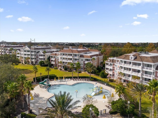 view of pool with a patio area and a water slide