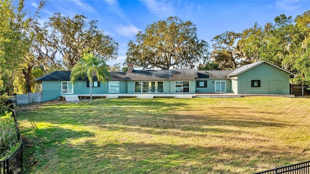 back of house featuring a yard